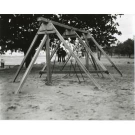 Swing seats buried in the sand on the Townsville Strand after the 1940 cyclone