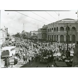 Soldiers and residents gather for the peace announcement, Flinders and Denham Street intersection, Townsville, 15th August 1945
