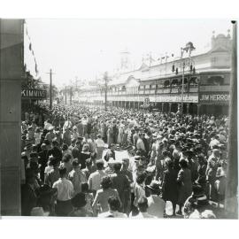 Soldiers and residents gather for the peace announcement, Flinders and Stokes Street intersection, Townsville, 15th August 1945