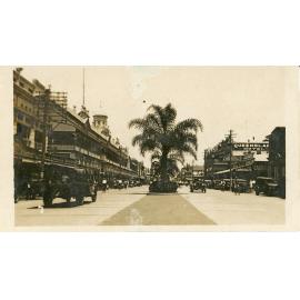 View of Flinders Street showing McKimmins & Richardson's store, the Queensland Hotel and Carroll's, Townsville, ca.1930
