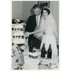 Gordon Wotherspoon and Pat Hughes cutting wedding cake, Townsville, 26 November 1954