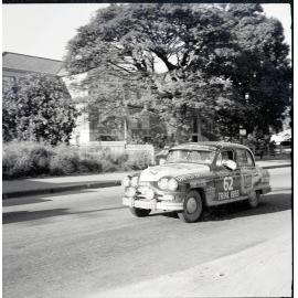 Car 62 in the Redex Trial 1955 on Ingham Road, Townsville. West End Primary School in the background