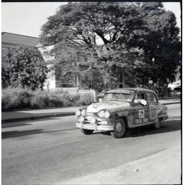 Car 62 in the Redex Trial 1955 on Ingham Road, Townsville. West End Primary School in the background