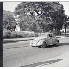 Car 48 in the Redex Trial 1955 on Ingham Road, Townsville. West End Primary School is in the background