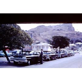 Official cars used for the visit of Princess Alexandra lined up outside Magnetic Motors in Blackwood Street, Townsville 1959