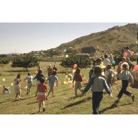 Children and balloons at an event at the Soundshell, South Townsville, 1985