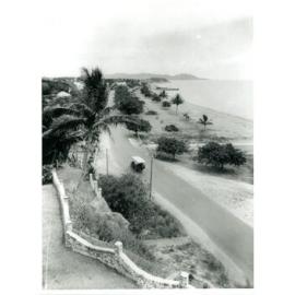 A bus travelling along the Townsville strand, 1930s