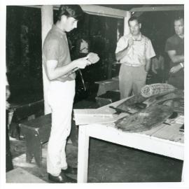 Prince Charles inspecting artefacts on a visit to North Queensland while attending Geelong Grammar School