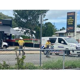 Ergon Energy staff removing fallen power line caused by Cyclone Kirrily on Ingham Road, West End