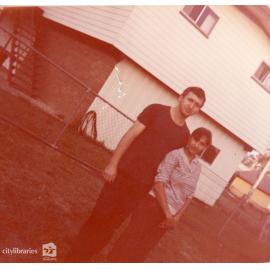 Man and woman standing in yard, Townsville, ca. 1980