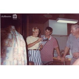 Staff of Carramar Children's Home looking at a document, Townsville, ca. 1990