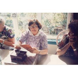 Staff member of Therapeutic Adolescent Residential Assessment Unit (TARA) with gifts and a card, Townsville, ca. 1995