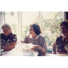 Staff member of Therapeutic Adolescent Residential Assessment Unit (TARA) opening a gift, Townsville, ca. 1995