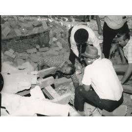 Inspecting bomb damage to Brothers Clubhouse, Gill Park, Townsville, 10 May, 1969