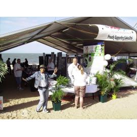 Staff member in front of exhibitions on the beach at Cultural Fest, Strand Park, Townsville, August 2007