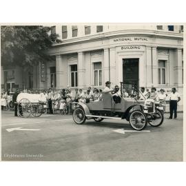 Vintage car and first ambulance entries in the Centenary Parade, corner of Flinders and Denham Street, Townsville, 7 November 1964