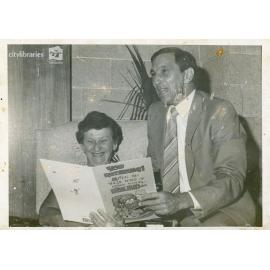 Staff members of Carramar Children's Home with a retirement card, Townsville, ca. 1975