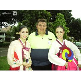Performers from Suwon City Korea, posing with a volunteer after the Tropigo Carnival parade at Cultural Fest, The Strand, Townsville, 18 August 2007