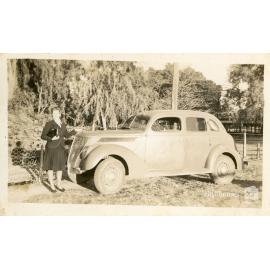 Person posing with a car, August 1944