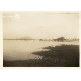 Cluden racecourse yard during flood, with Cluden station and Castle Hill, Townsville [10 February 1946]