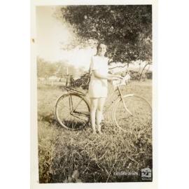 May Garrow standing with a bicycle, Townsville, ca. 1946