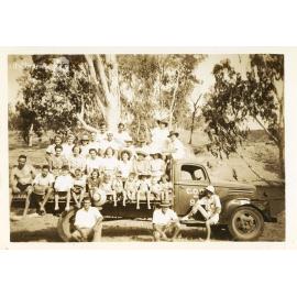 The crowd that went to the C.O.D. picnic posing on the back of a truck, Alice River, Townsville, 1946