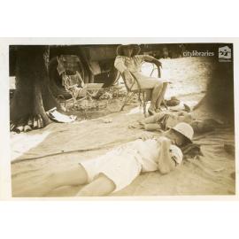 Mr Brown lying down at the C.O.D. picnic, Alice River, Townsville, 1946