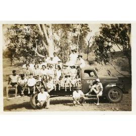 Group posing on the back of a truck, C.O.D. picnic,  Alice River, Townsville, 1946