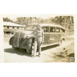 Reg Simmons posing in front of a vehicle, Townsville, ca. 1946