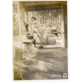 Woman washing her feet in an outdoor basin, [Magnetic Island], Townsville, ca. 1949