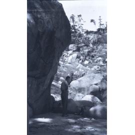 Arthur (Doug) Armstrong standing by a campfire, Alma Bay, Magnetic Island, [between 1908 and 1930].