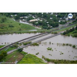 River level skirts under Rooney's Bridge, aerial photograph during floods, Oonoonba, 2019. 