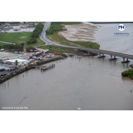 Harbourside Coldstores and trawler unload wharf, Tropical Containers, Old Pacific Marine Group barge unloading ramp, Southern Port Road bridge, aerial photograph during floods, 2019. 