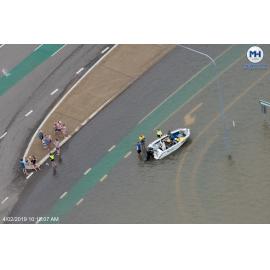 People and boat off Abbott Street, aerial photograph during floods, 2019. 