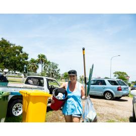 Hermit Park AFL Club volunteer carrying cleaning supplies, Hermit Park, 2019