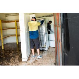 Hermit Park AFL Club volunteers removing flood damaged appliances, Hermit Park, 2019