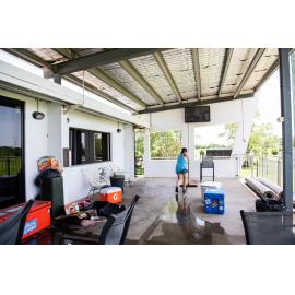 Hermit Park AFL Club volunteer sweeping level 1 veranda, Hermit Park, 2019