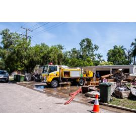 SES Volunteers and truck emptying storage shed, damaged goods piled on driveway and footpath, Hermit Park, 2019