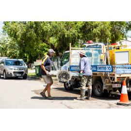 Residents/Volunteers loading damaged tv onto Mitre 10 truck for removal, Hermit Park, 2019