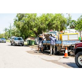 Residents/Volunteers loading damaged tv onto Mitre 10 truck for removal, Hermit Park, 2019