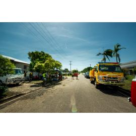 Community food tent with Residents/Volunteers collecting food and drink, SES Vehicle parked on street, Hermit Park, 2019