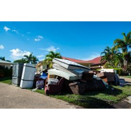 Damaged household goods lining streets of flood affected street, Idalia, 2019