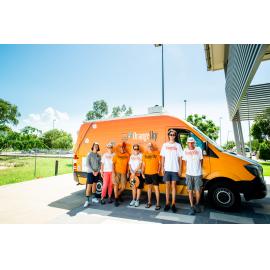 Orange Sky Australia workers/volunteers standing in front of company van outside Townsville Stadium, Murray, 2019.