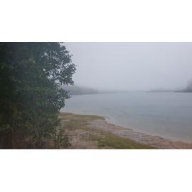Heavy rain falling over Paluma Dam during flood, 2019.