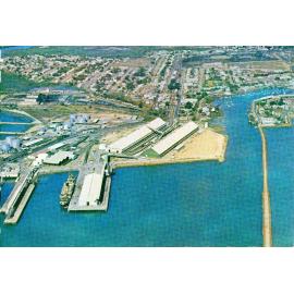 Aerial view of bulk loading of zinc, with sugar sheds, at Townsville harbour